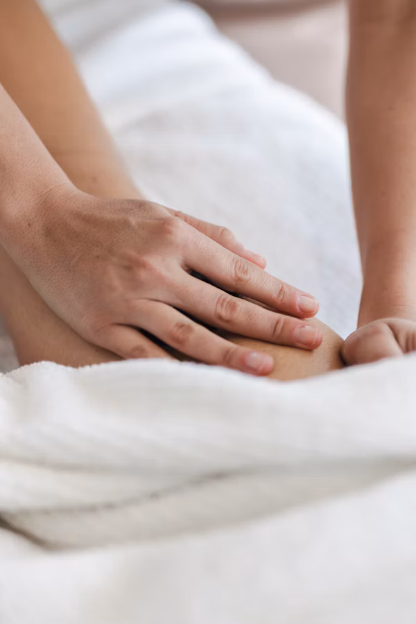 Leg massage over a white towel