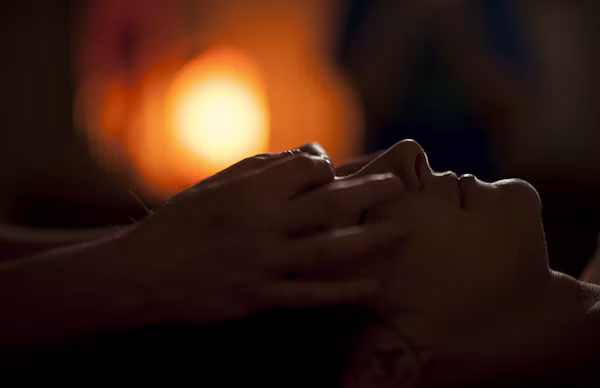 Face massage in warm, dim light